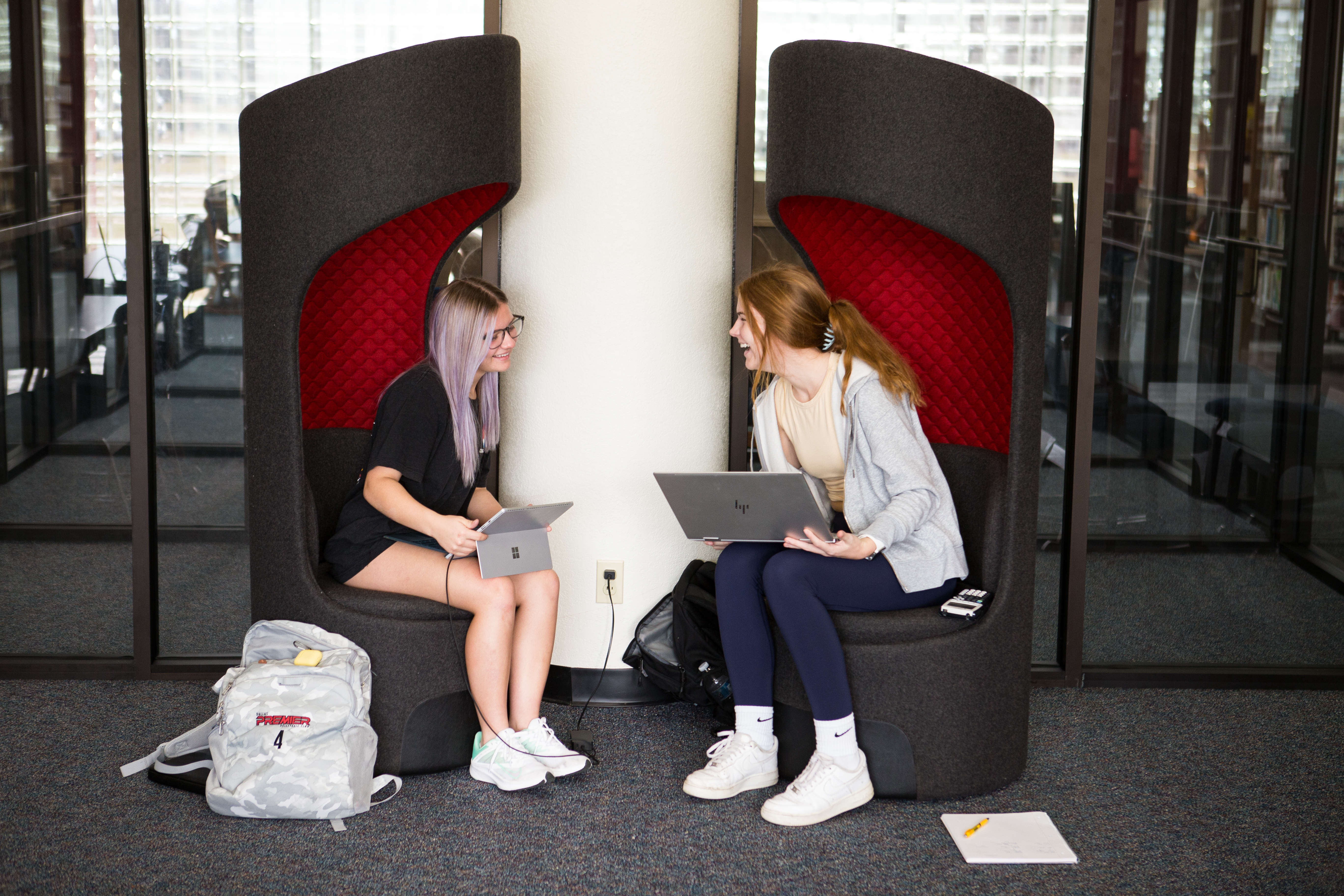 Students sitting with laptops in Gainesville library