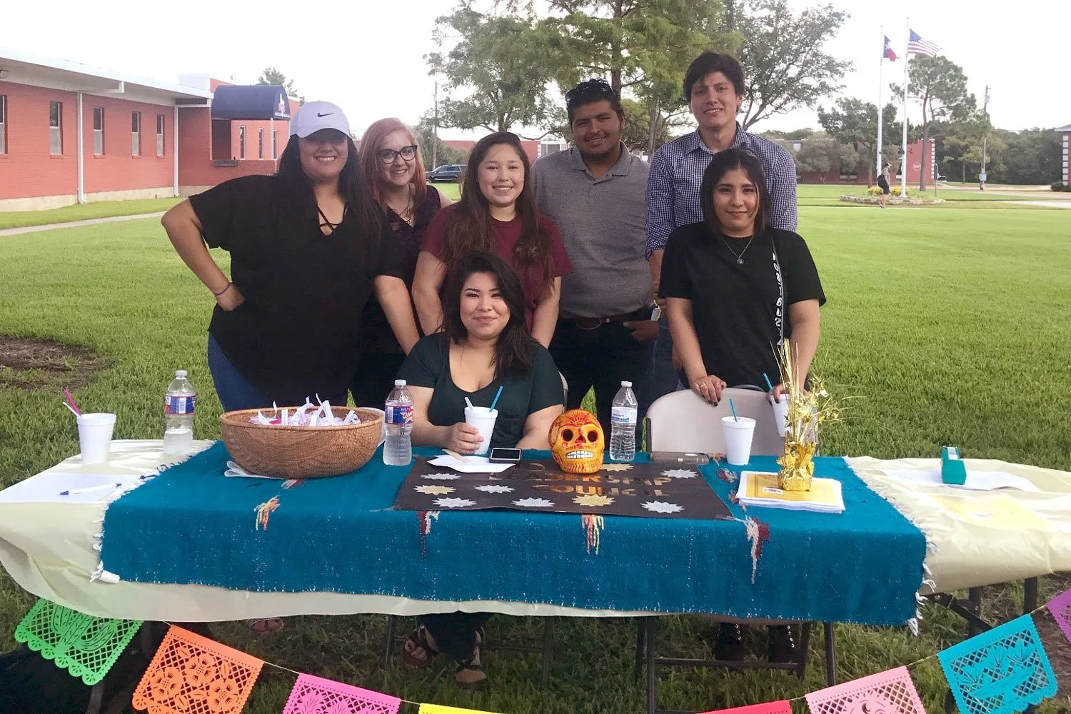 students sitting at a table representing their student organization