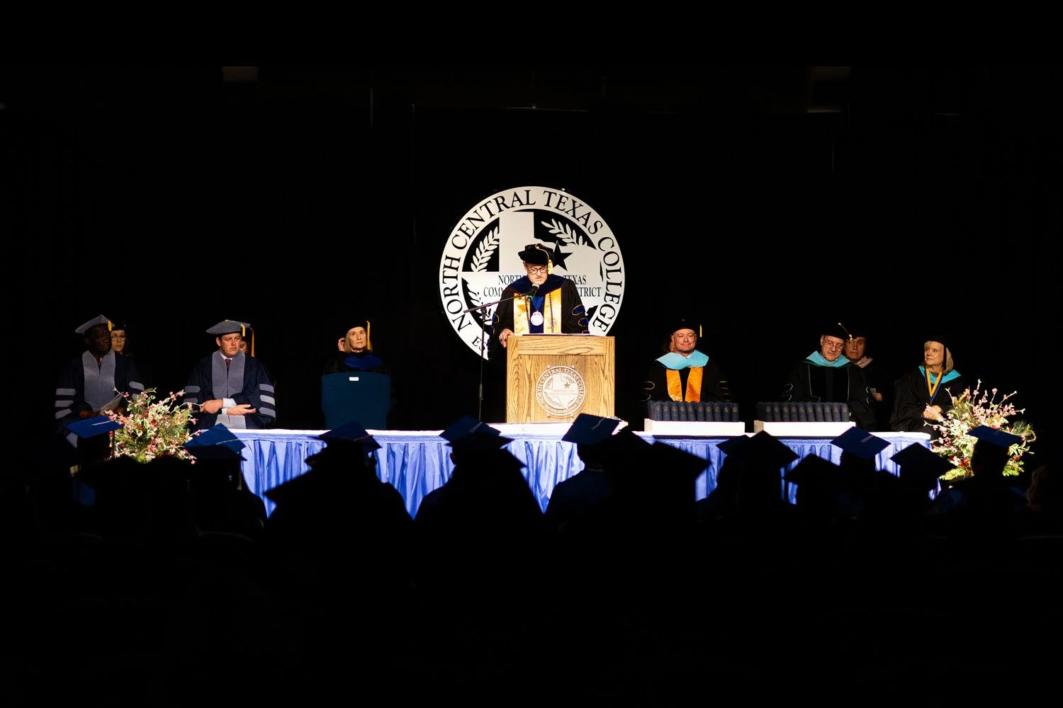 commencement-ceremony-on-stage-with-faculty-staff